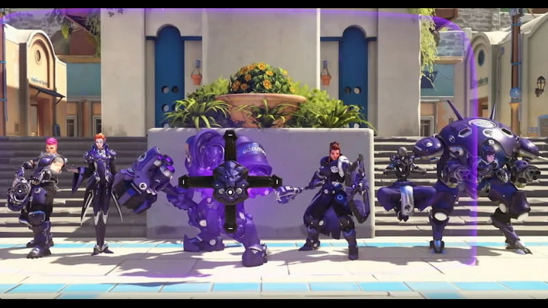 Overwatch karaktärer står framför en byggnad, förberedda för strid med sina rustningar och vapen.
