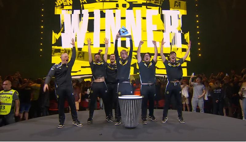 Ett lag firar seger på scenen med en trofé, texten "WINNER" i bakgrunden, från BLAST Open Spring 2025.