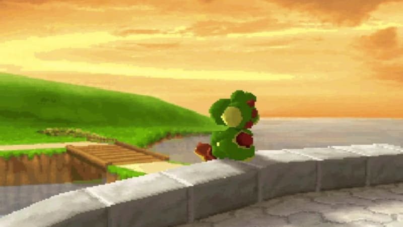 Grön dinosaurie (Yoshi) sitter på en mur och tittar ut över vattnet vid solnedgången.