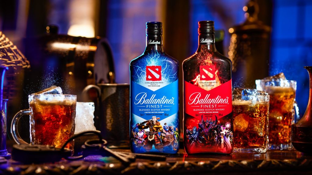 Image of Ballantine's Dota 2 whiskey bottles next to glasses of alcohol