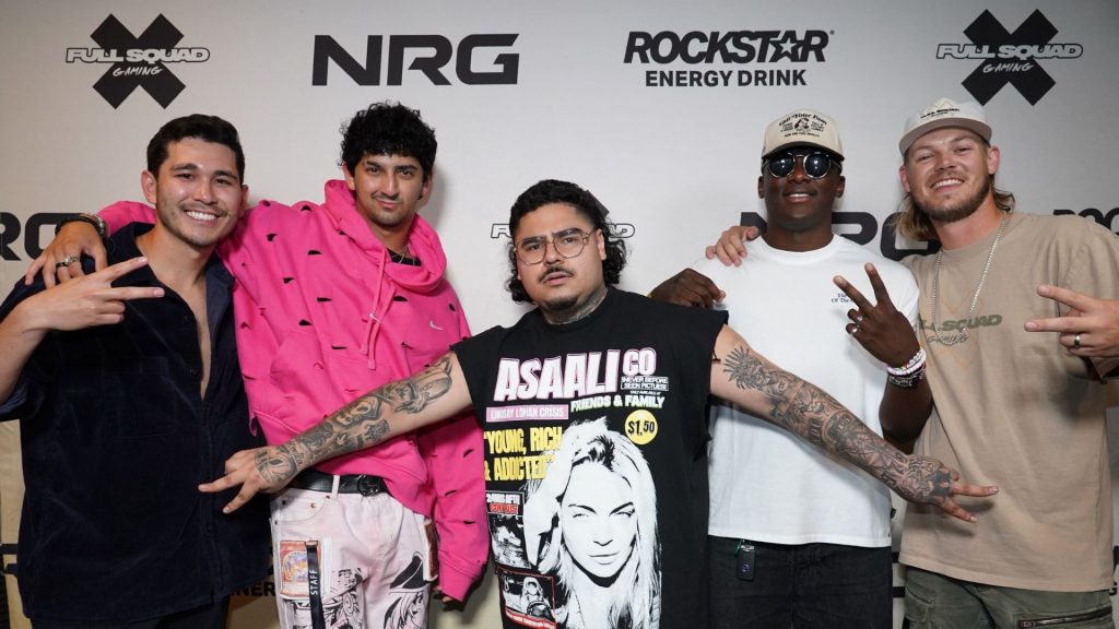Image of NRG Full Squad Gaming members posing in front of wall with NRG, Full Squad Gaming, and Rockstar Energy logos