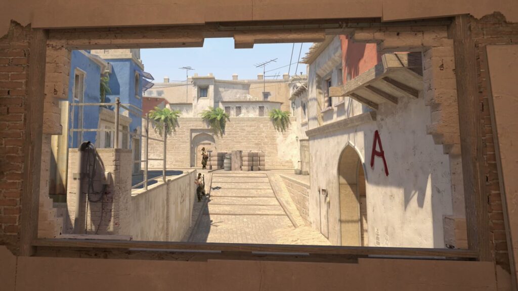 View through a window in Counter-Strike, showing a sunlit street lined with palm trees and buildings, where two players gear up for action.