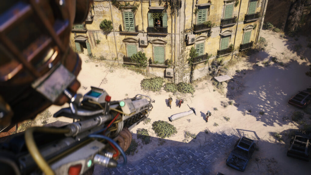 First-person view of a futuristic weapon aimed at a courtyard where characters stand near a fallen missile — from Arc Raiders.