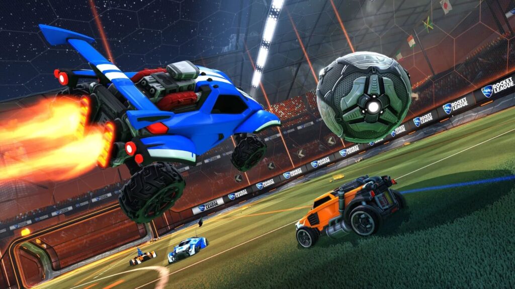 A blue rocket car boosts into the air, aiming at a metallic soccer ball, while two other cars compete on a vibrant, futuristic pitch.