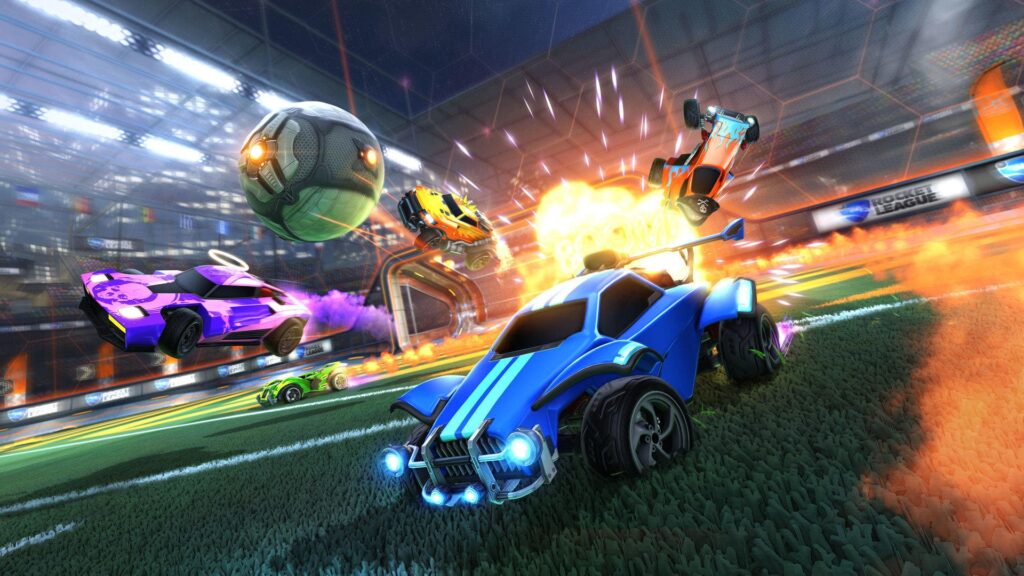 A dynamic scene from Rocket League, featuring colorful cars soaring into the air, aiming for a glowing soccer ball amidst explosive visuals.
