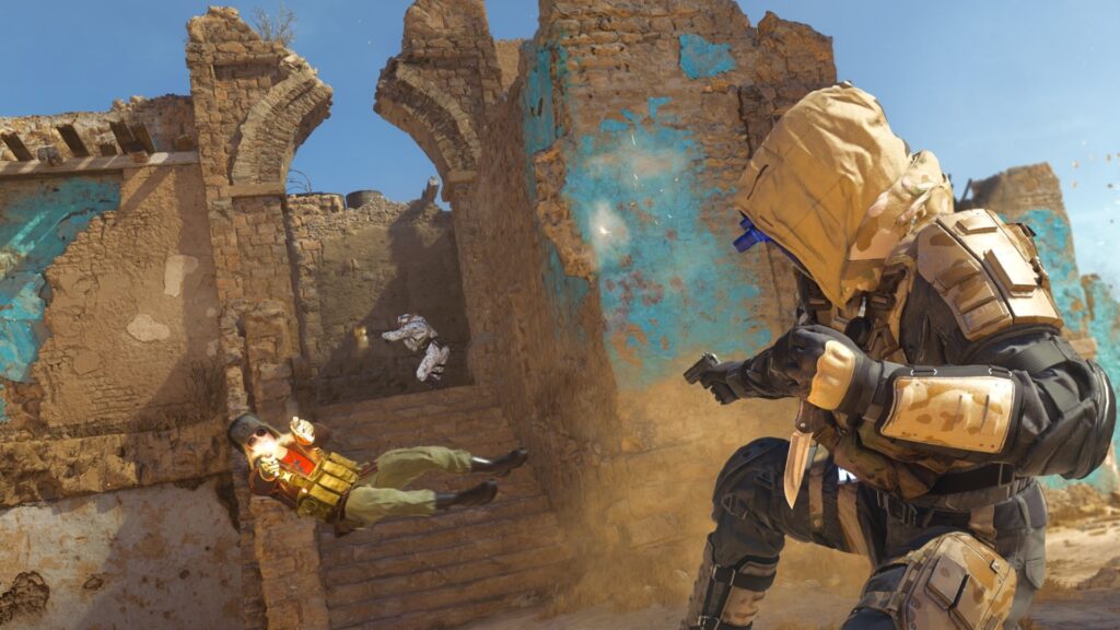 Image of Black Ops 6 player crouching in foreground. Another player is diving while firing two weapons in front of a ruined building in the background
