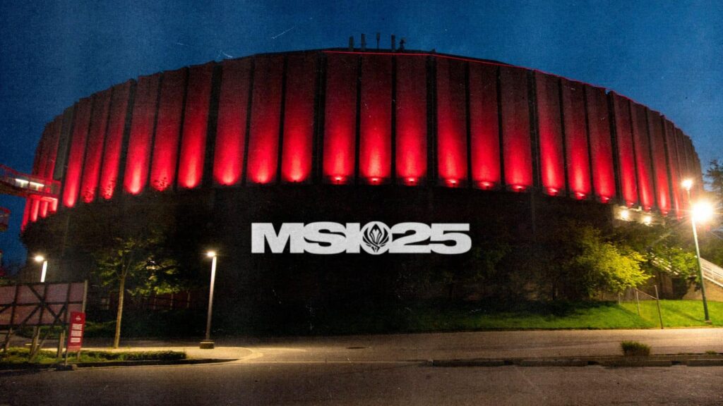 Exterior of an arena lit up in red lights at night with the MSI 2025 logo projected on the building