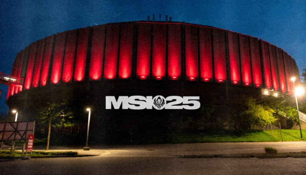 The exterior of a circular arena illuminated in red light, showcasing a prominent "MSI 25" logo at night.