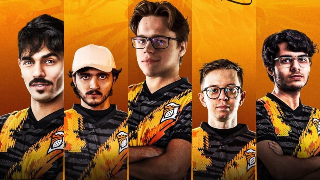 Image of Fog Esports players wearing jerseys and posing on an orange background