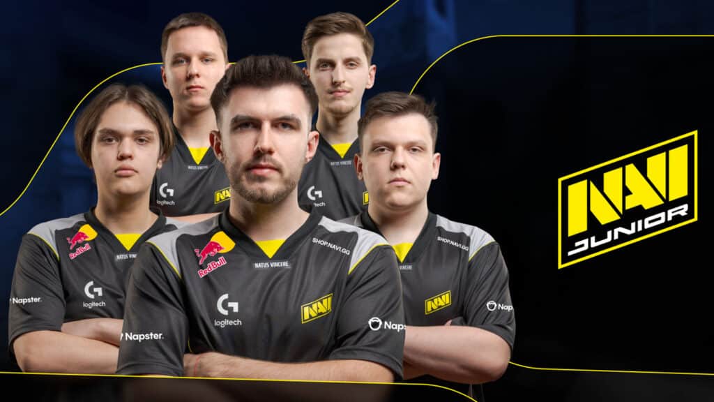 Image of NAVI Junior posing with arms folded on a dark blue background. The NAVI Junior logo is next to the players on the right-hand side