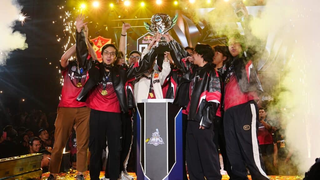 Image of Selangor Red Dragons OG Esports lifting MPL Malaysia trophy. Gold confetti is flying through the air in the background