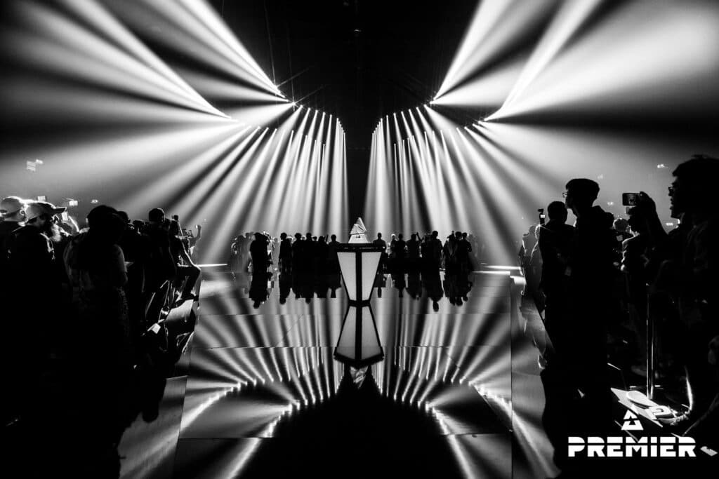 BLAST Premier stage with trophy and crowd, black and white filter.