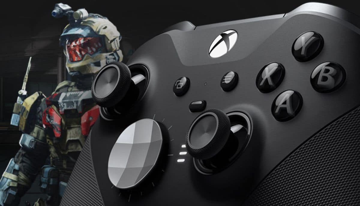 Close-up of a black Xbox controller with textured grips and buttons, alongside a futuristic soldier in combat armor