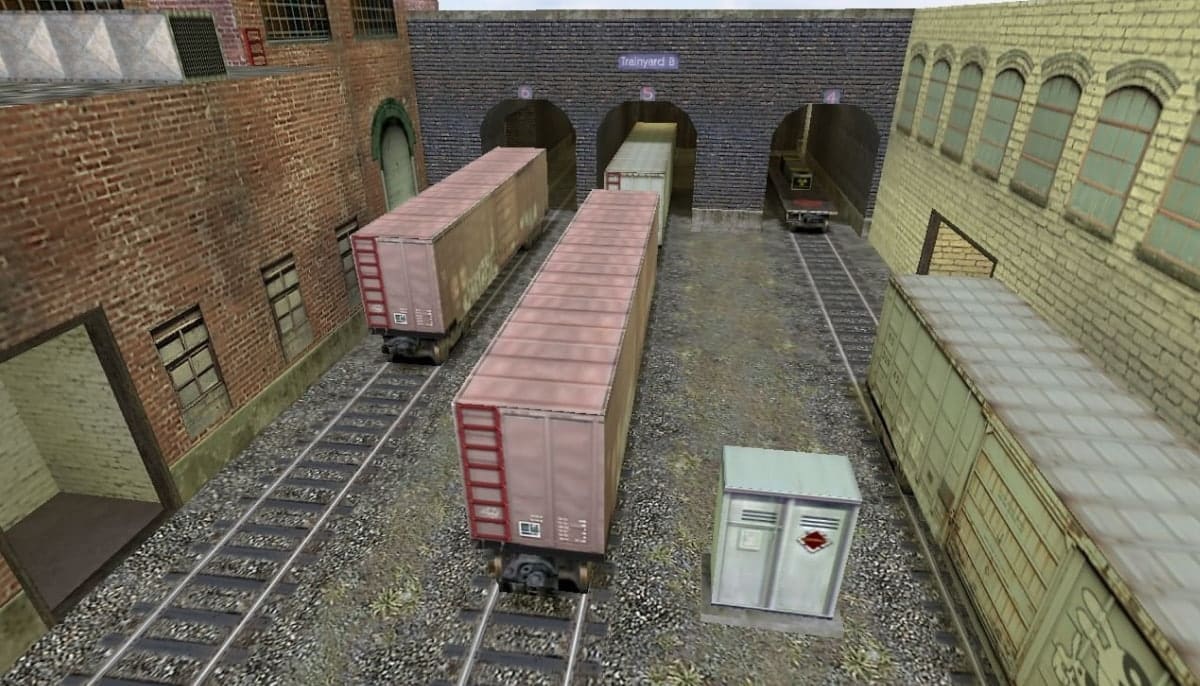 Rail yard scene with rusty red and green boxcars on tracks beside brick and stone warehouses in CS2