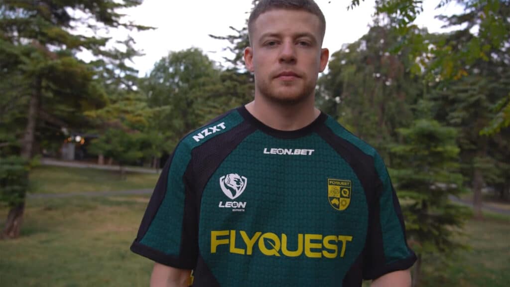 Image of jks wearing a FlyQuest jersey with trees in the background