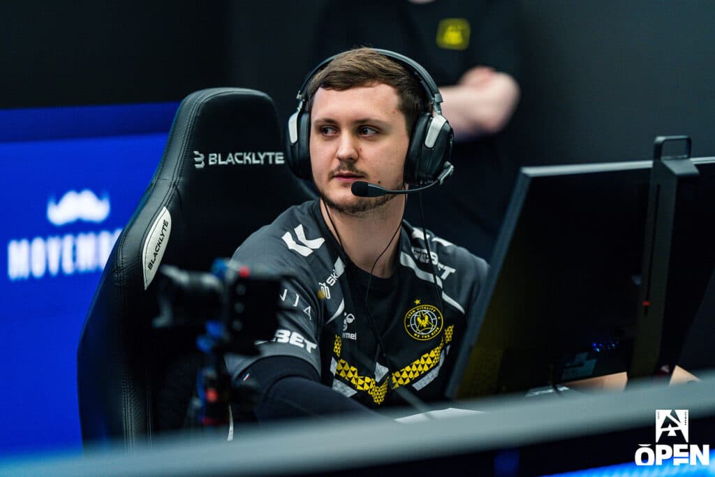 Image of Mezii competing at Counter-Strike event. He is wearing a Team Vitality jersey and a headset.