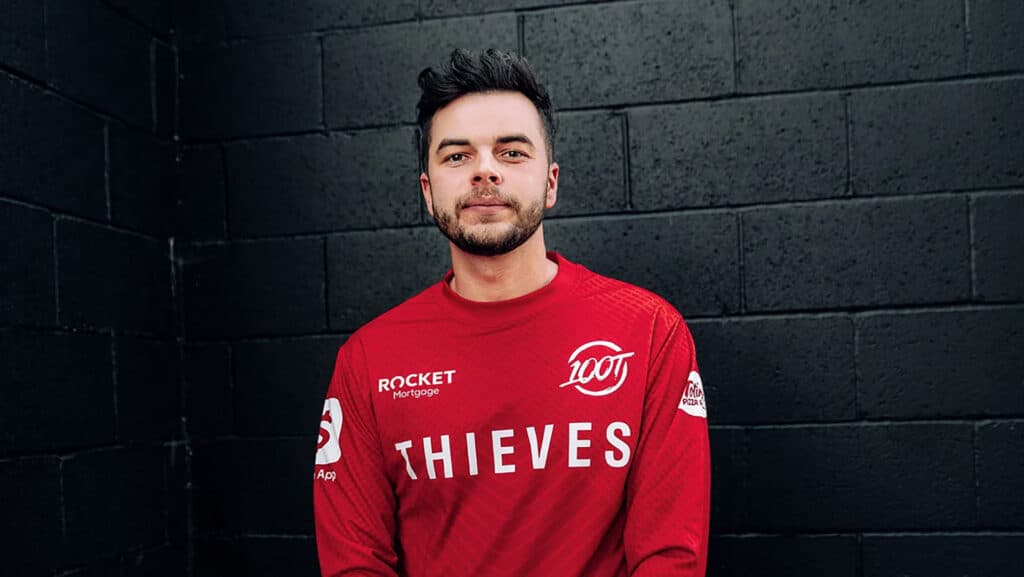 Image of Matt 'Nadeshot' Haag wearing red 100 Thieves while standing against a black wall
