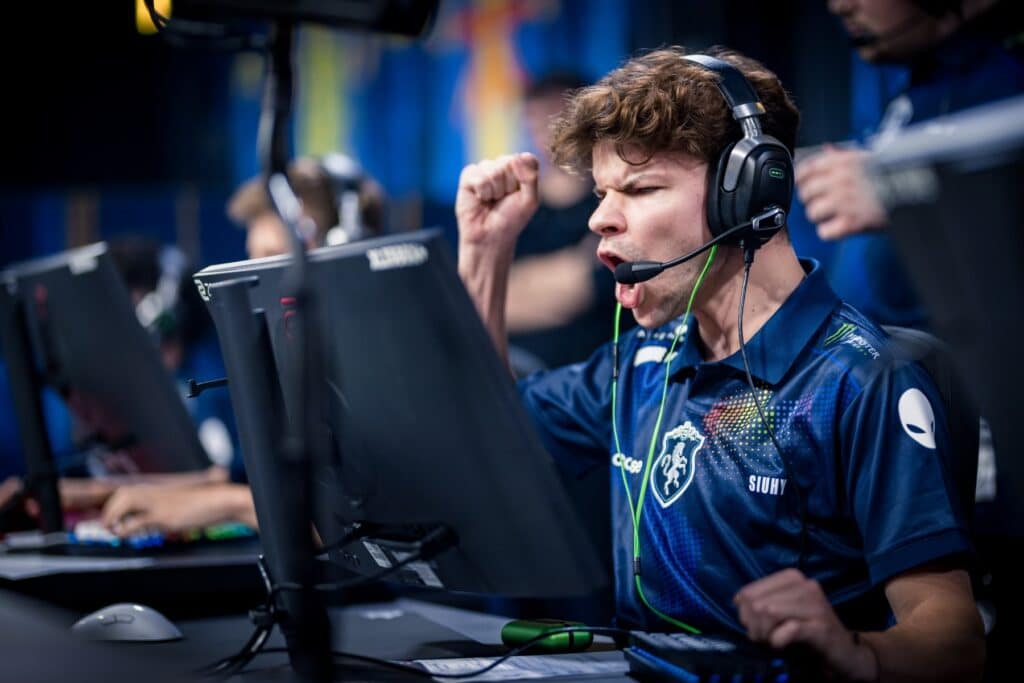 Image of Siuhy competing at IEM Cologne 2025. The player is cheering with fist in the air while wearing Team Liquid jersey