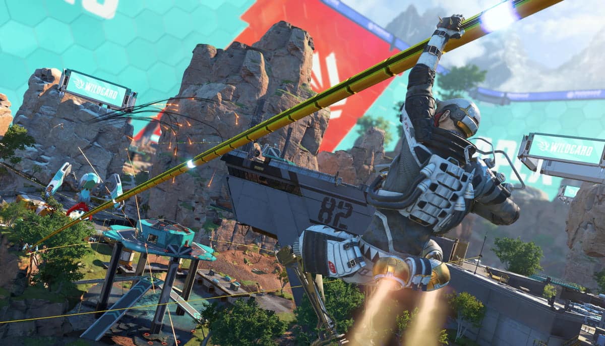 A futuristic character in sleek armor glides along a zipline across a rocky, high-tech landscape