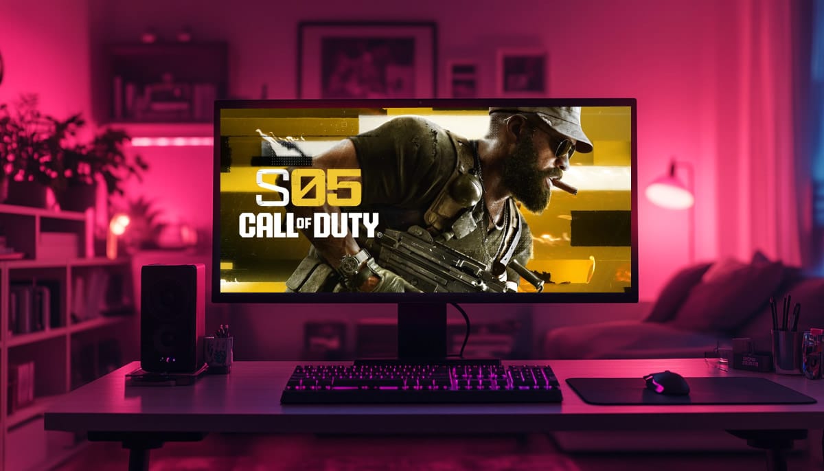 A gaming setup with a monitor displaying a Call of Duty: S05 scene, featuring a soldier with a rifle, surrounded by a desk with a keyboard, mouse, and pink lighting in a cozy room