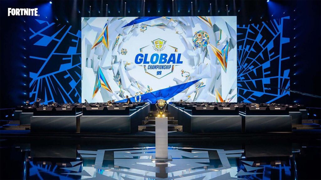 Image of Fortnite Global Championship 2024 stage with a trophy placed on a stand in the foreground. The FNCS logo is displayed on a large screen in the background