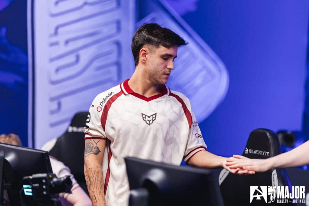 Image of HEROIC Counter-Strike player holding the hand of another player at the BLAST Austin Major