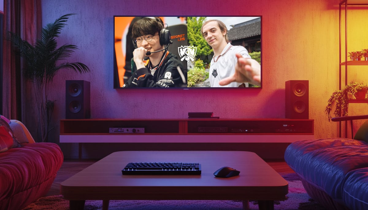 A cozy living room with a large TV displaying a split-screen video of two gamers, one smiling with headphones, the other joyfully gesturing