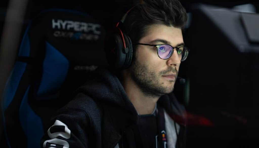 Esports player focused at his gaming setup with headset on