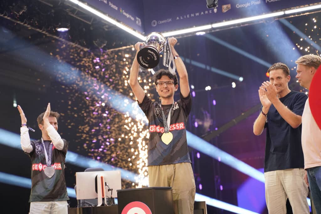 Image of Geoguessr player Radu C holding Geoguessr World Cup trophy on stage