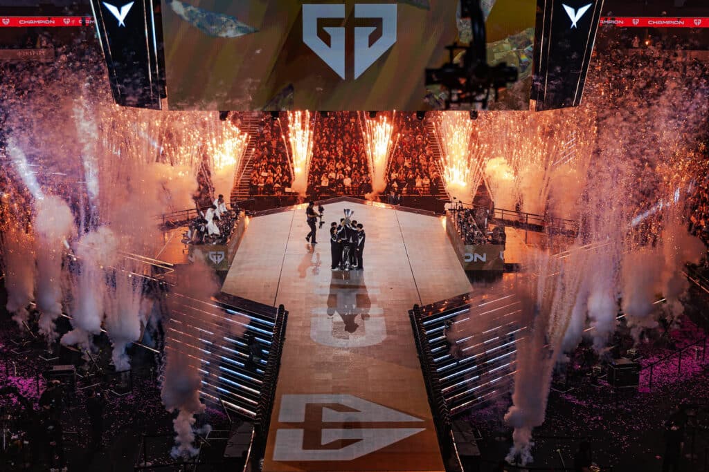 Image of Gen.G standing on LCK stage with pyrotechnics surrounding the outer edge of the stage