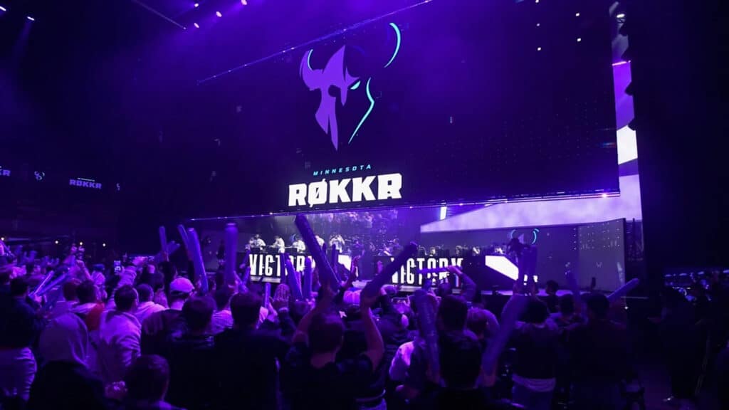 Image of Minnesota Rokkr logo displayed on a large screen above a Call of Duty League stage. A crowd celebrating is in the foreground