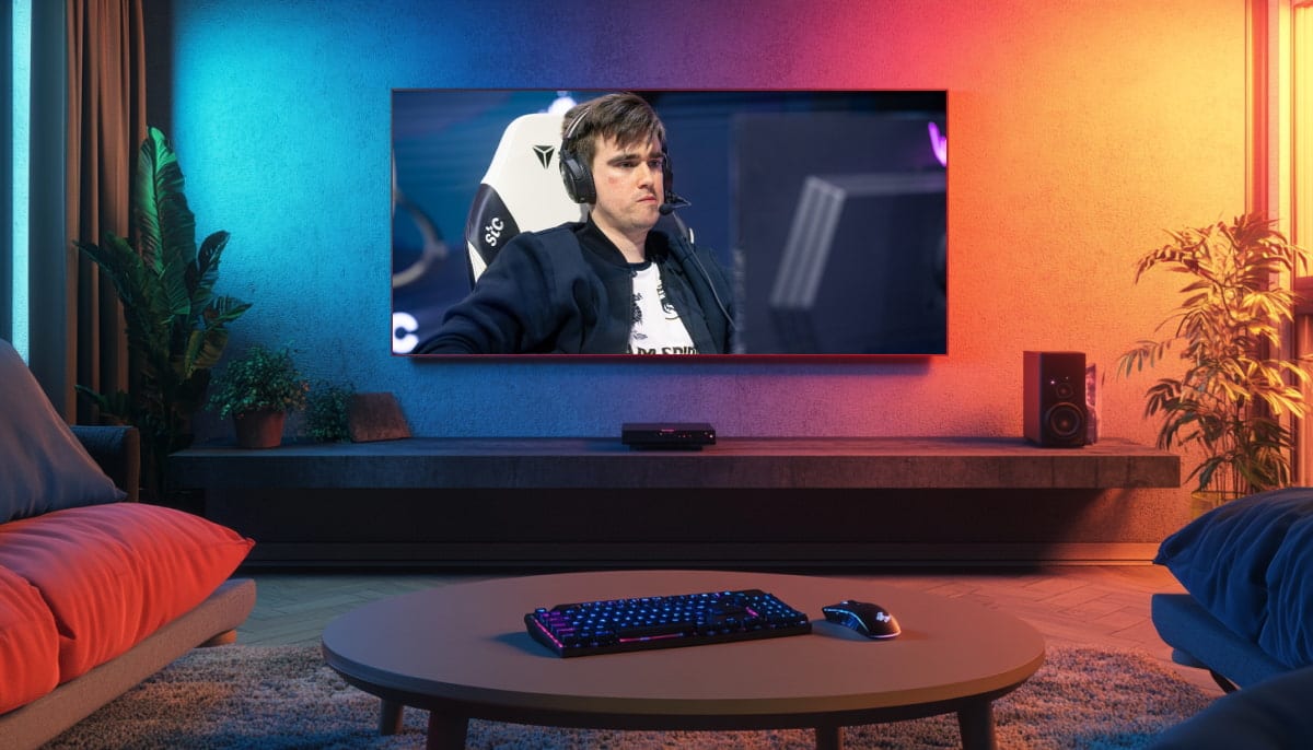 A cozy, dimly-lit living room with a large TV displaying Miposhka