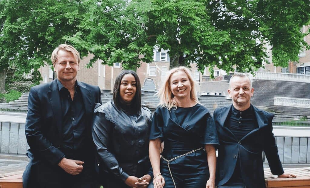 Image of Esports Global team smiling with a tree and a building in the background