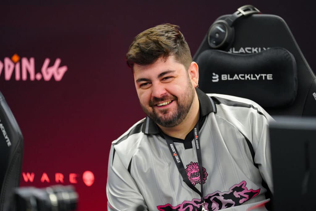 Image of Gentle Mates Counter-Strike 2 coach smiling while sitting at Counter-Strike esports event