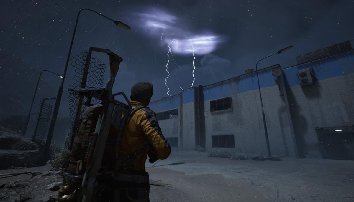 A person stands facing a stormy night sky with lightning illuminating dark clouds in Arc Raiders