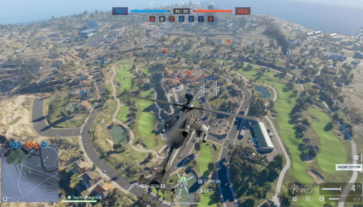 Aerial view from a helicopter flying over a gaming map with lush greenery, roads, and buildings in BF 6