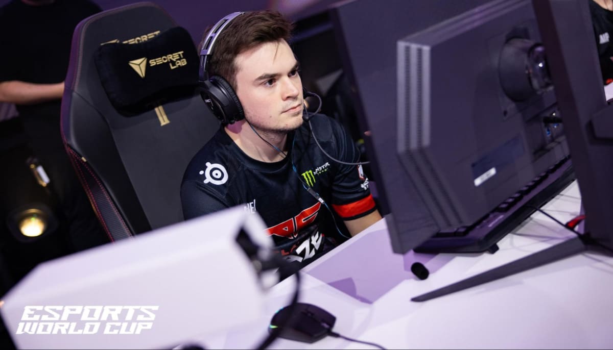 Tyler Pharris aka aBeZy wearing headphones is seated at a gaming setup during the Esports World Cup