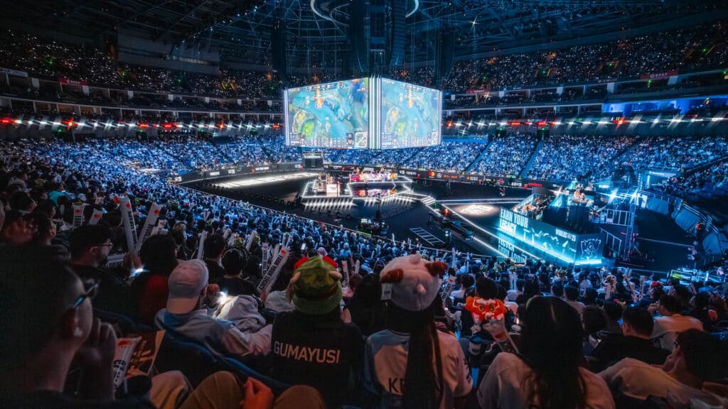 Image of League of Legends World Championship stage in centre of arena surrounded by crowd