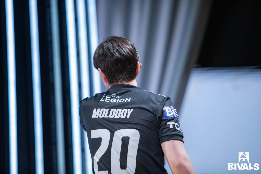 Image of Counter-Strike player Molodoy standing walking towards the back of an esports stage