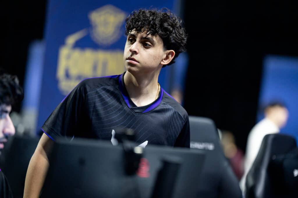 Image of Fortnite player Boltz standing up near gaming setup at Fortnite esports event