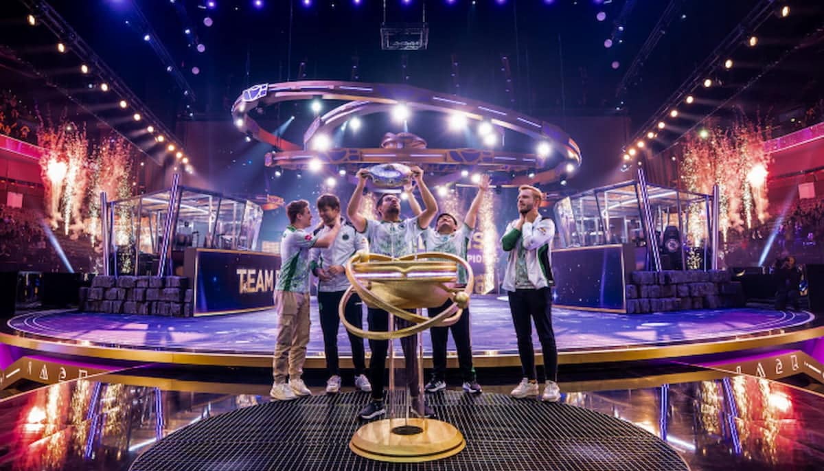 The image captures the moment when the Team Falcons esports team celebrates its victory at The International 2025 tournament in the game Dota 2