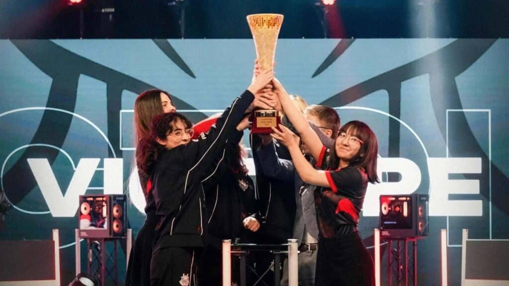 Image of G2 Hel lifting Equal Esports Cup trophy while on stage