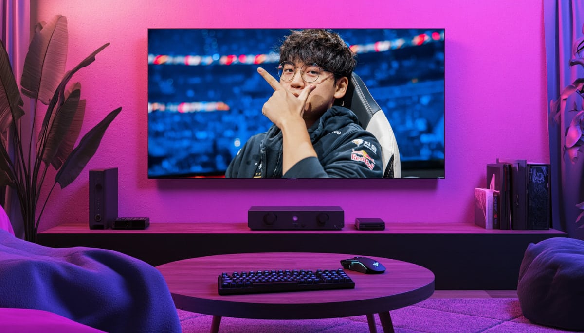 A living room setup with purple ambient lighting, showing Gumayusi