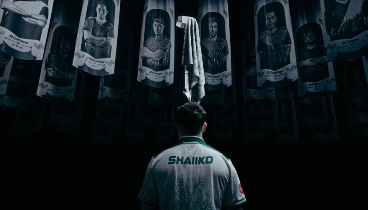 A man from behind, wearing a white and green esports jersey with the name "SHAAIKO" written on the back, stands in a dark room and looks up at a series of banners hanging from the ceiling. Each banner features a black and white portrait of a different person