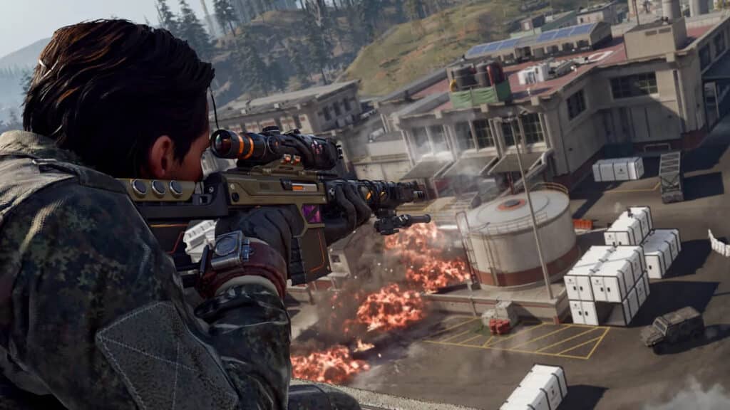 Image of Call of Duty Warzone player aiming with sniper rifle. Explosions are destroying buildings in the background