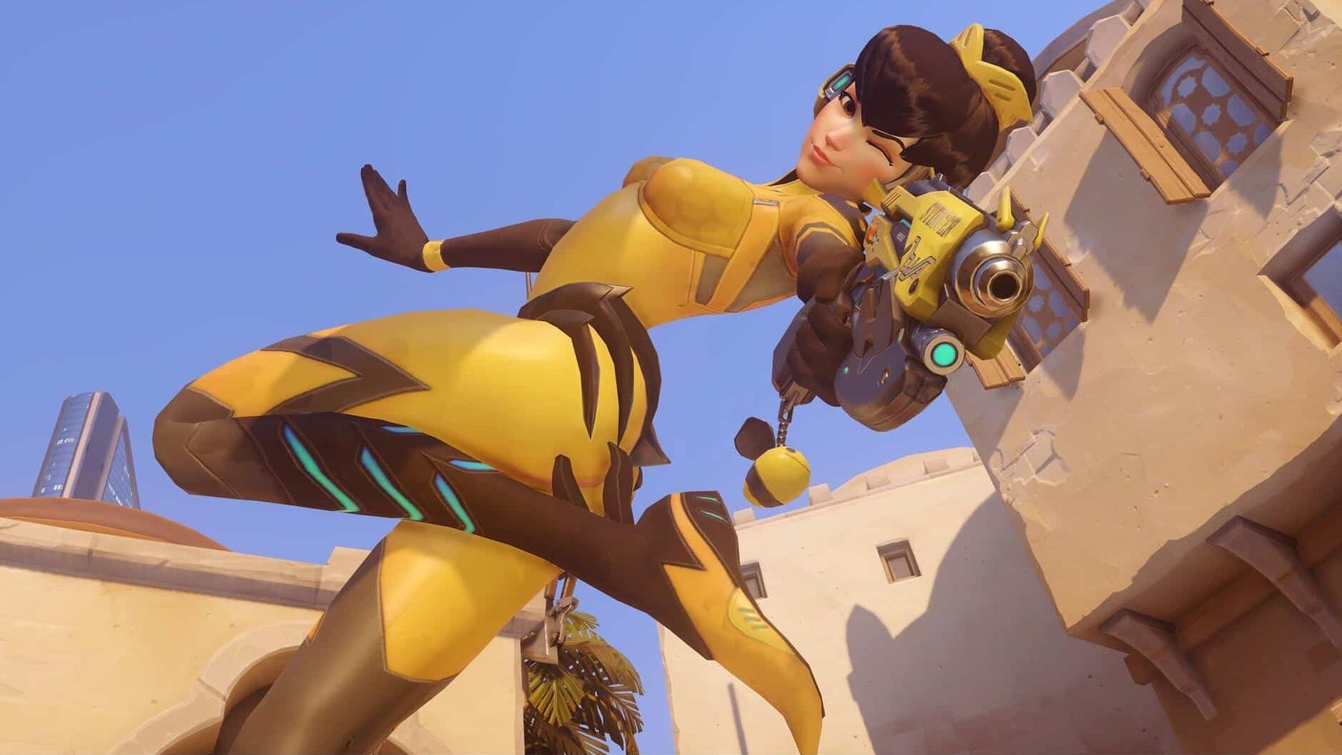 B.Va in a dynamic yellow and brown suit strikes a playful pose with one arm out and a wink