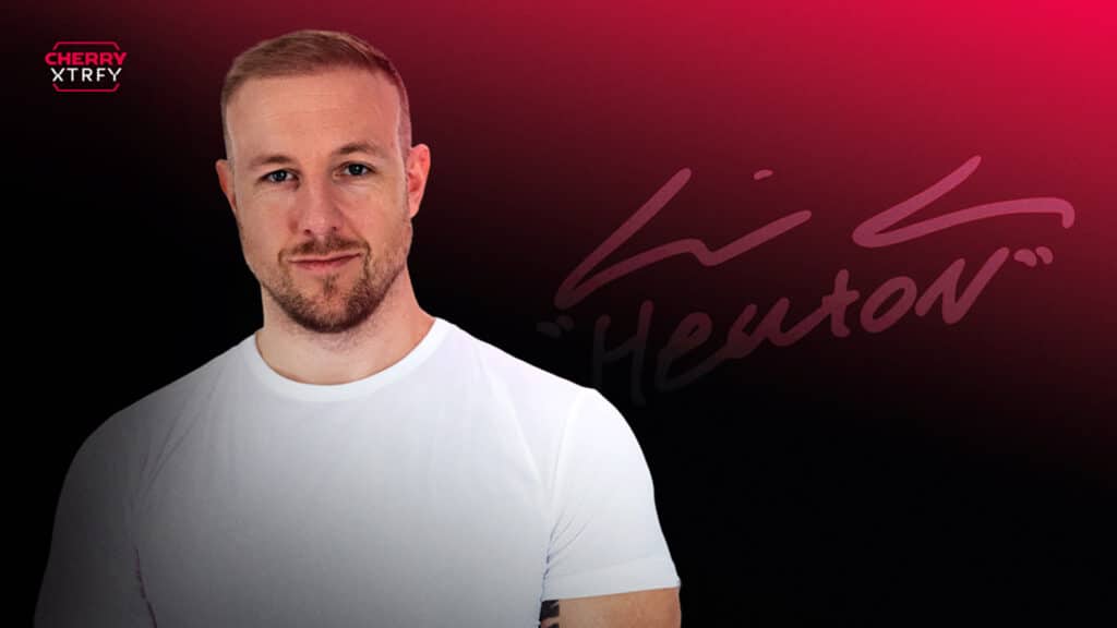 Image of former Counter-Strike player HeatoN wearing white shirt on a dark red background. The Cherry XTRFY logo is in the top left corner.