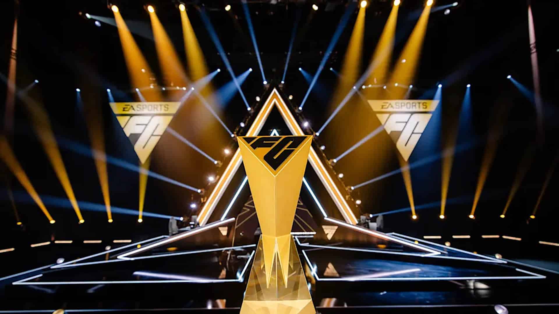 Image of EA Sports FC Pro World Championship trophy in the centre of a stage illuminated with gold lighting