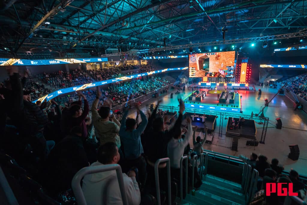 Image of PGL Cluj-Napoca CS2 tournament stage. A crowd celebrates the action displayed on large screens