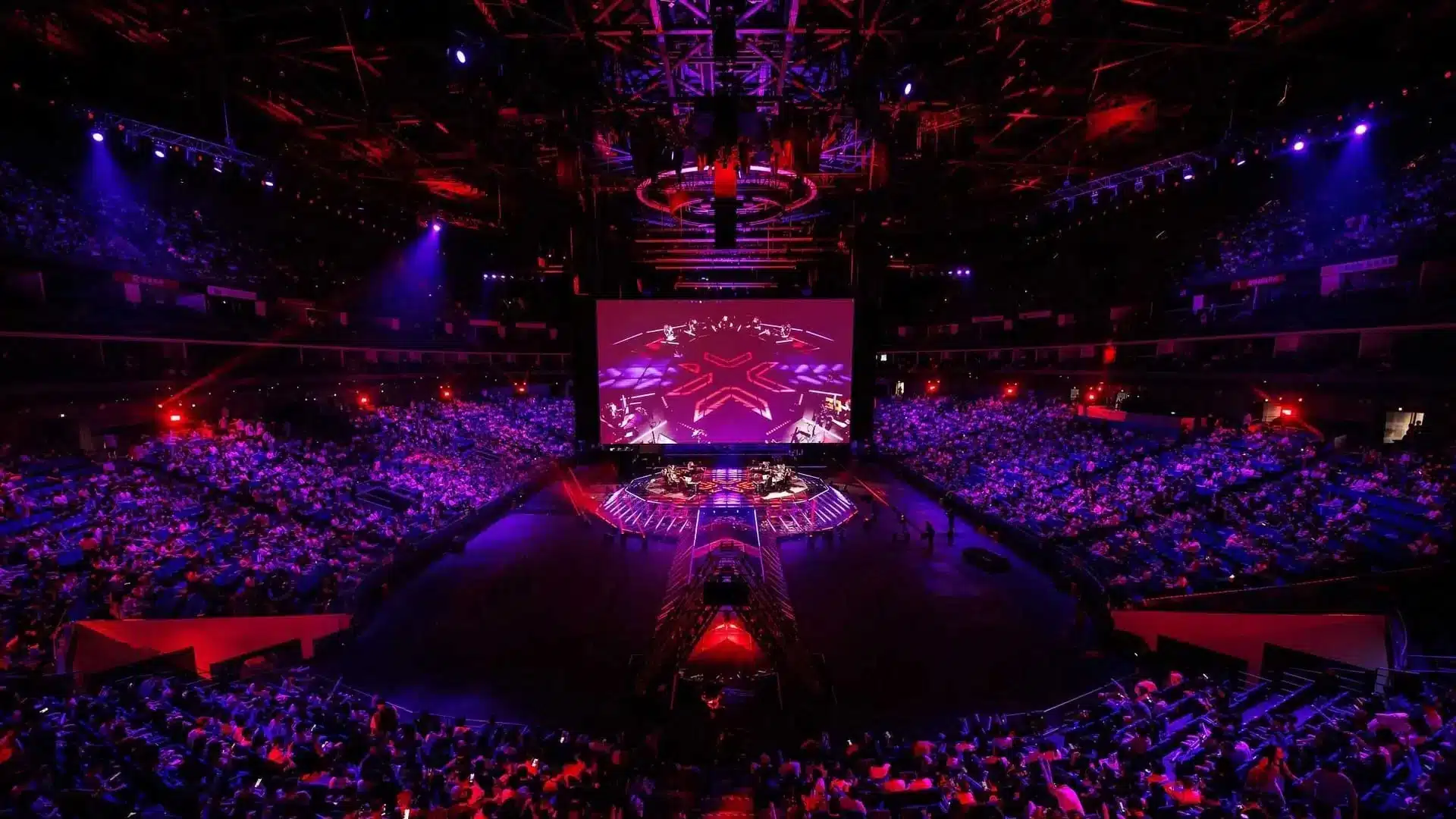 Wide shot of the VALORANT Champions Shanghai arena stage and audience under red and purple lighting.